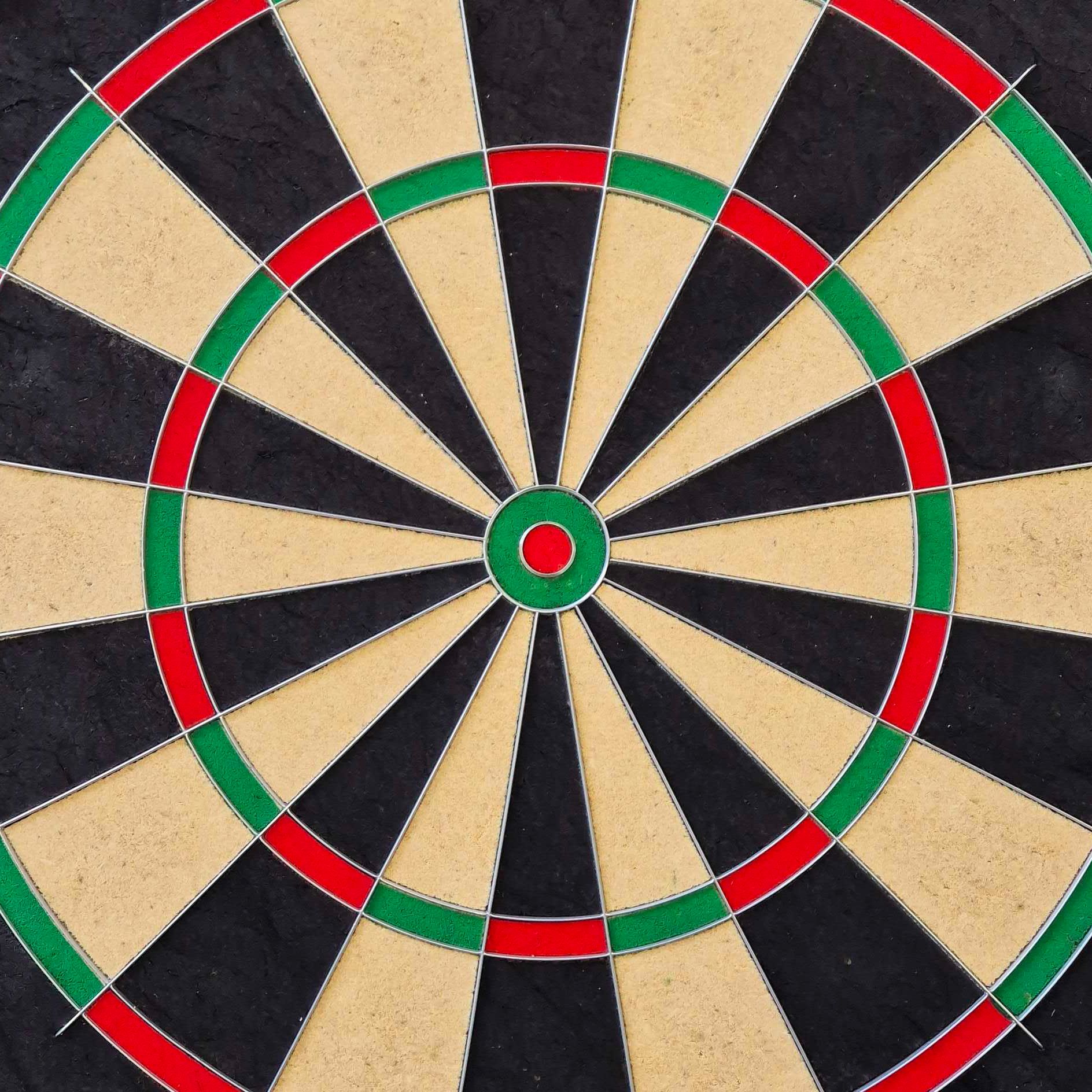 Das Bild zeigt eine Steeldart-Scheibe mit den klassischen Farben Schwarz, Beige, Rot und Grün. Es handelt sich um das Produkt "Unicorn Eclipse Smartboard Steeldartboard".