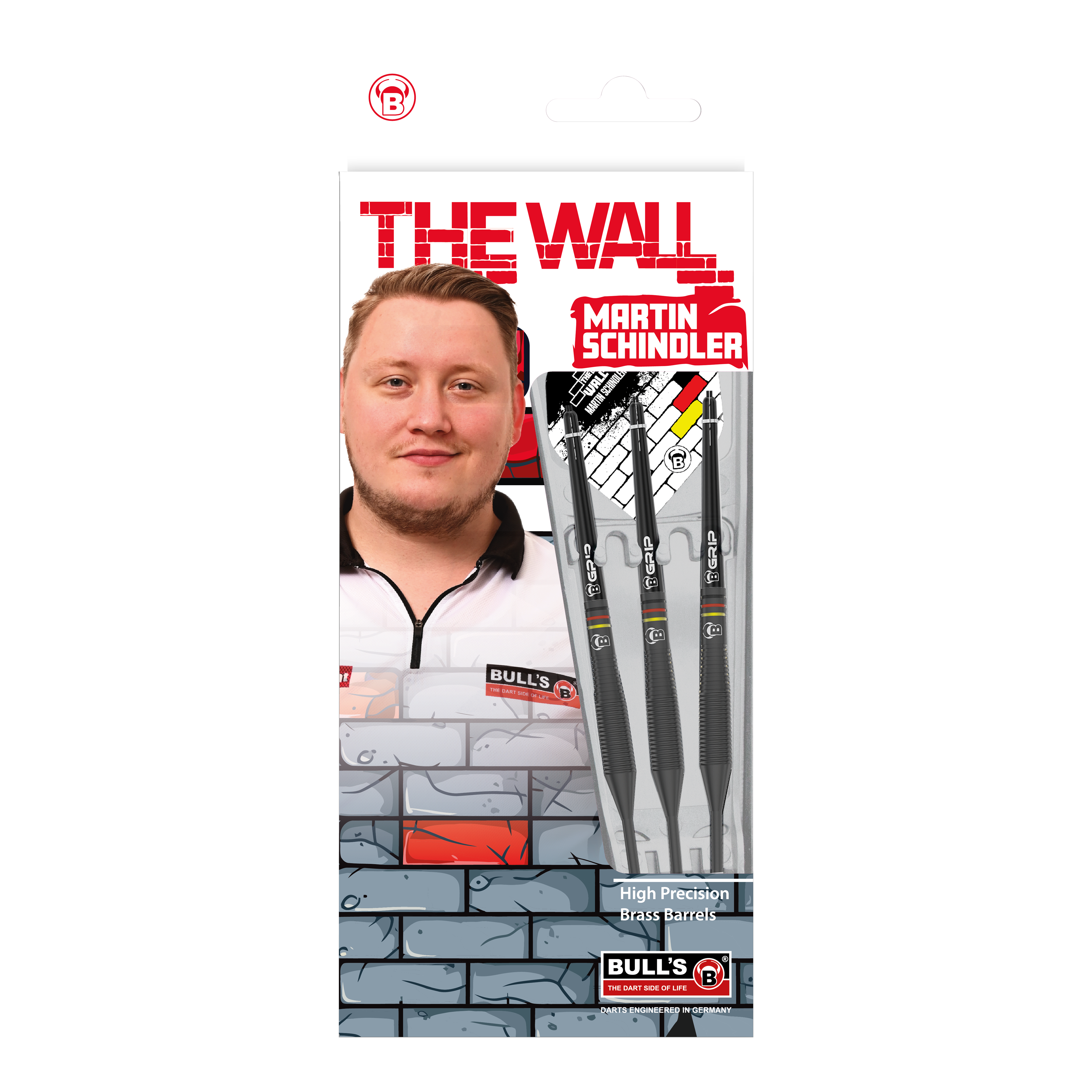 Auf dem Bild ist die Verpackung der "Bulls Martin Schindler The Wall Black Brass Steeldarts" zu sehen. Auf der Vorderseite sind das Produkt, ein Porträt von Martin Schindler und das Markenlogo abgebildet.