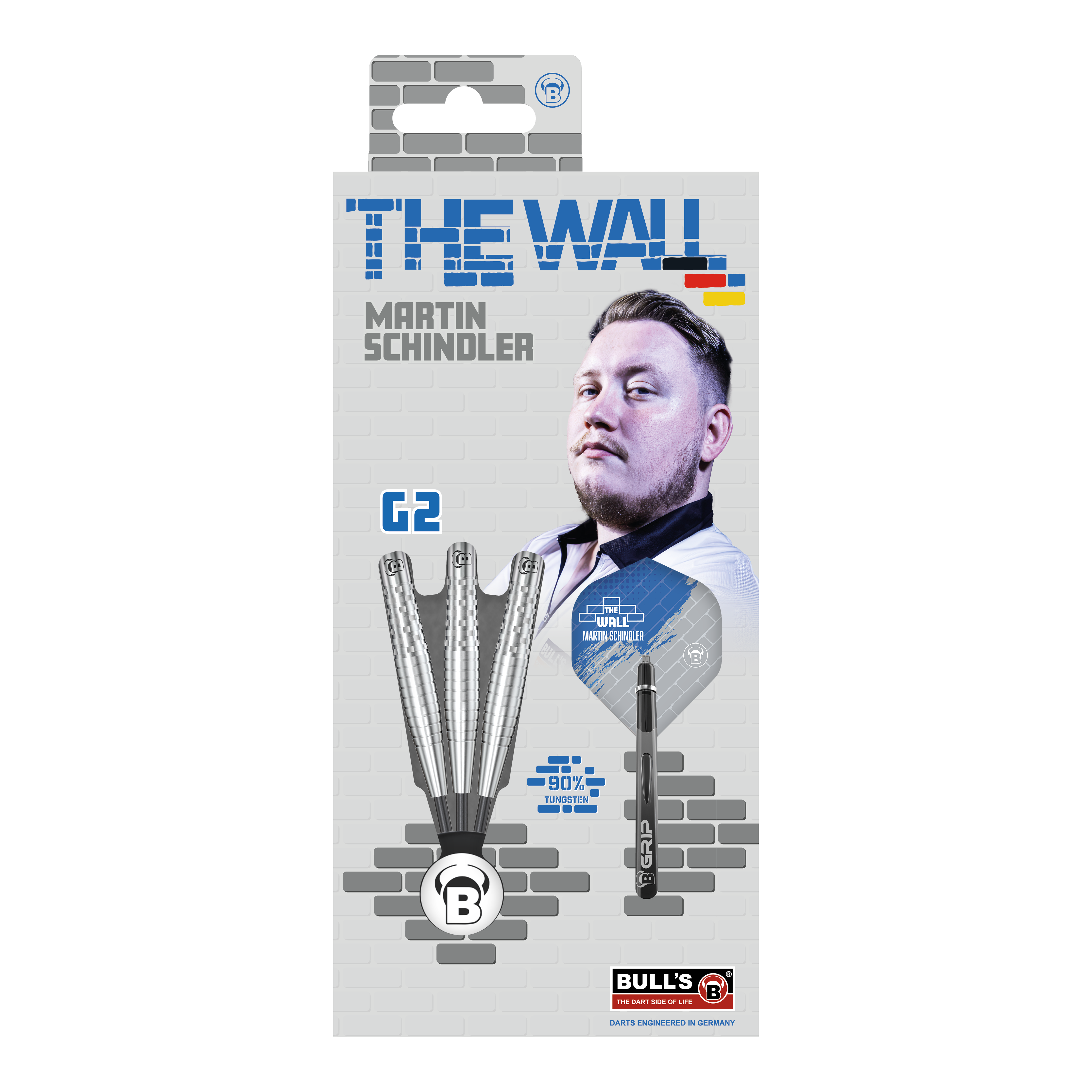 Rzutki stalowe Bulls Martin Schindler Original Generation 2 Die Verpackung zeigt die "Bulls Martin Schindler Original Generation 2 Steeldarts" mit dem Bild von Martin Schindler. Auf der Vorderseite sind drei Darts und die Aufschrift "THE WALL" sowie "90% Tungsten" abgebildet.