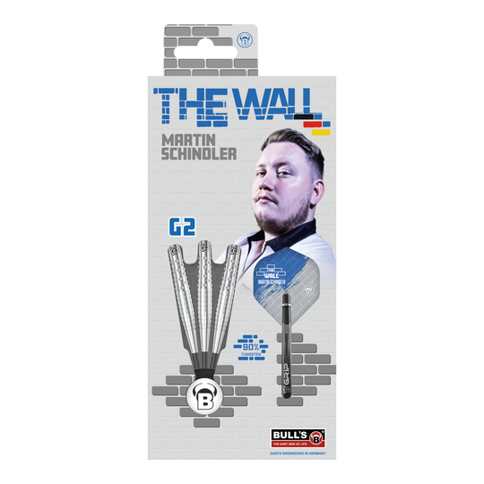 Rzutki stalowe Bulls Martin Schindler Original Generation 2 Die Verpackung zeigt die "Bulls Martin Schindler Original Generation 2 Steeldarts" mit dem Bild von Martin Schindler. Auf der Vorderseite sind drei Darts und die Aufschrift "THE WALL" sowie "90% Tungsten" abgebildet.