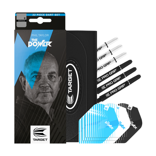 Das Bild zeigt das Produkt "Target Phil Taylor Brass Softdarts - 18g" mit Verpackung und Zubehörteilen. Zu sehen sind Dartspitzen, Flights und Schäfte sowie die markante Verpackung mit dem Portrait von Phil Taylor.