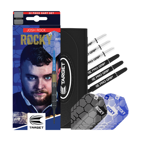 Target Josh Rock Brass Soft Darts - 18g Das Bild zeigt das Produkt "Target Josh Rock Brass Softdarts - 18g" mit Zubehör wie Flights und Shafts. Auf der Verpackung ist ein Porträt sowie der Name des Spielers Josh Rock zu sehen.